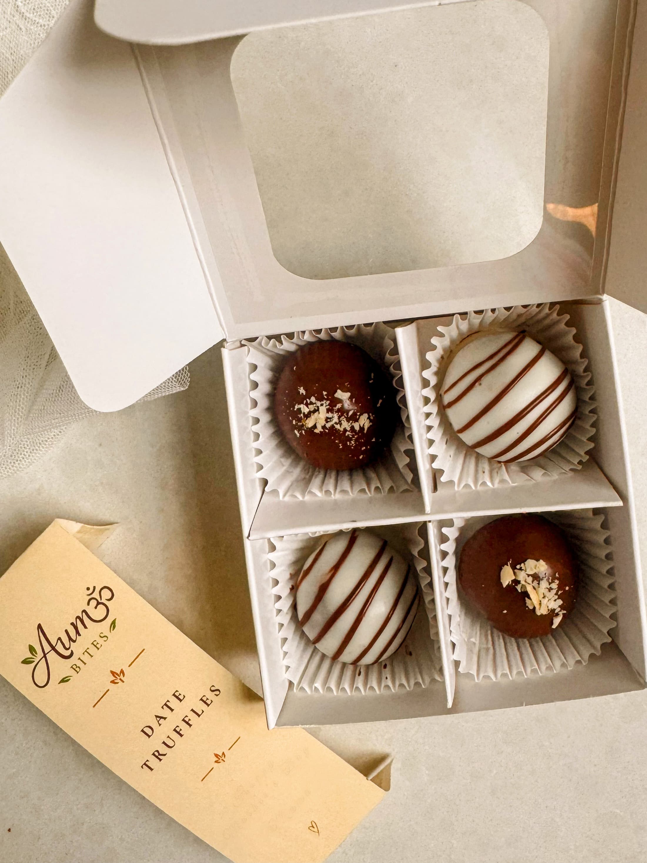 Aum Truffles — hand-rolled date and nut truffles in a gift box with assorted toppings