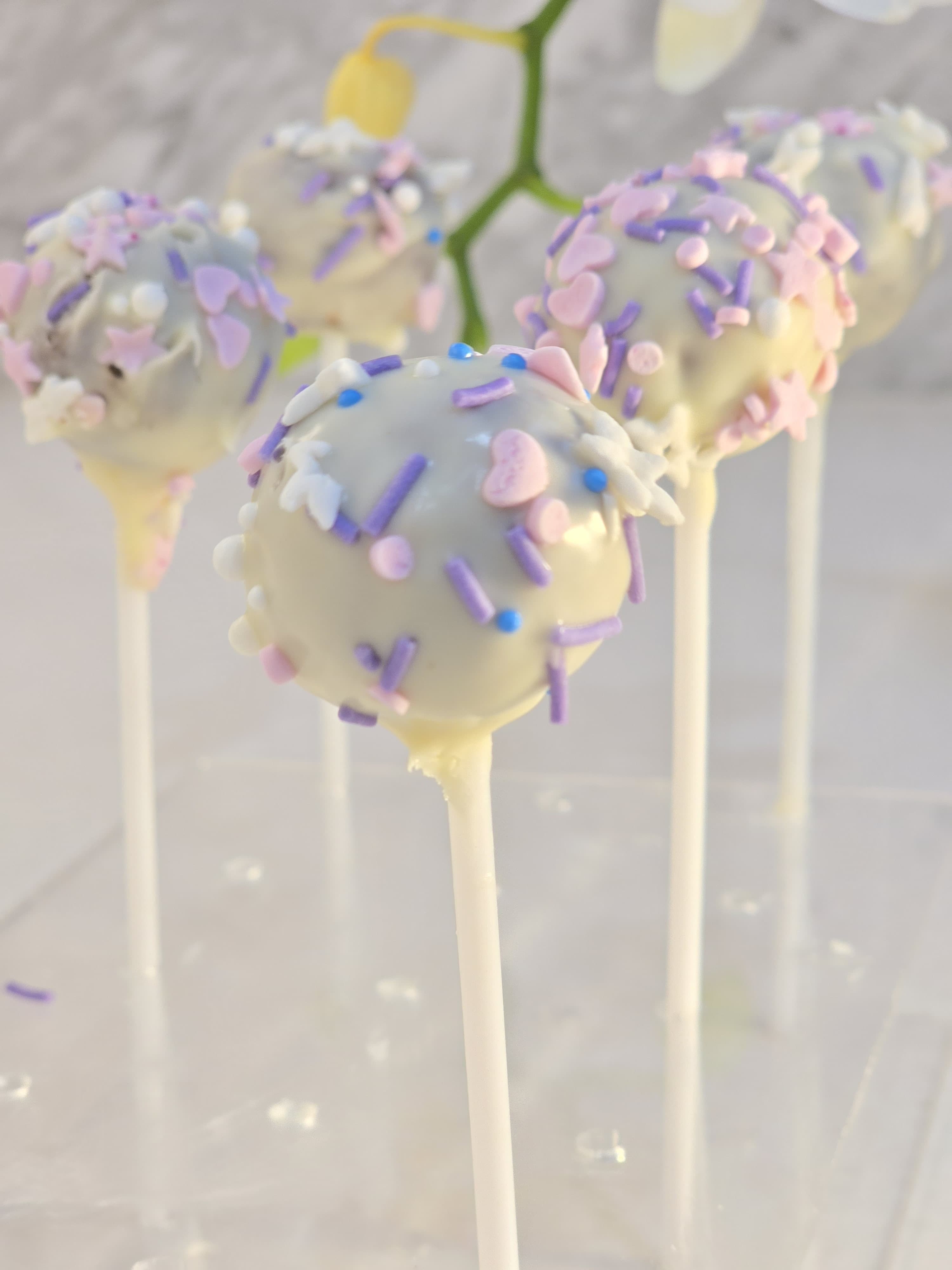 Aum Pops — date and nut bites on sticks, dipped in candy coating and chocolate