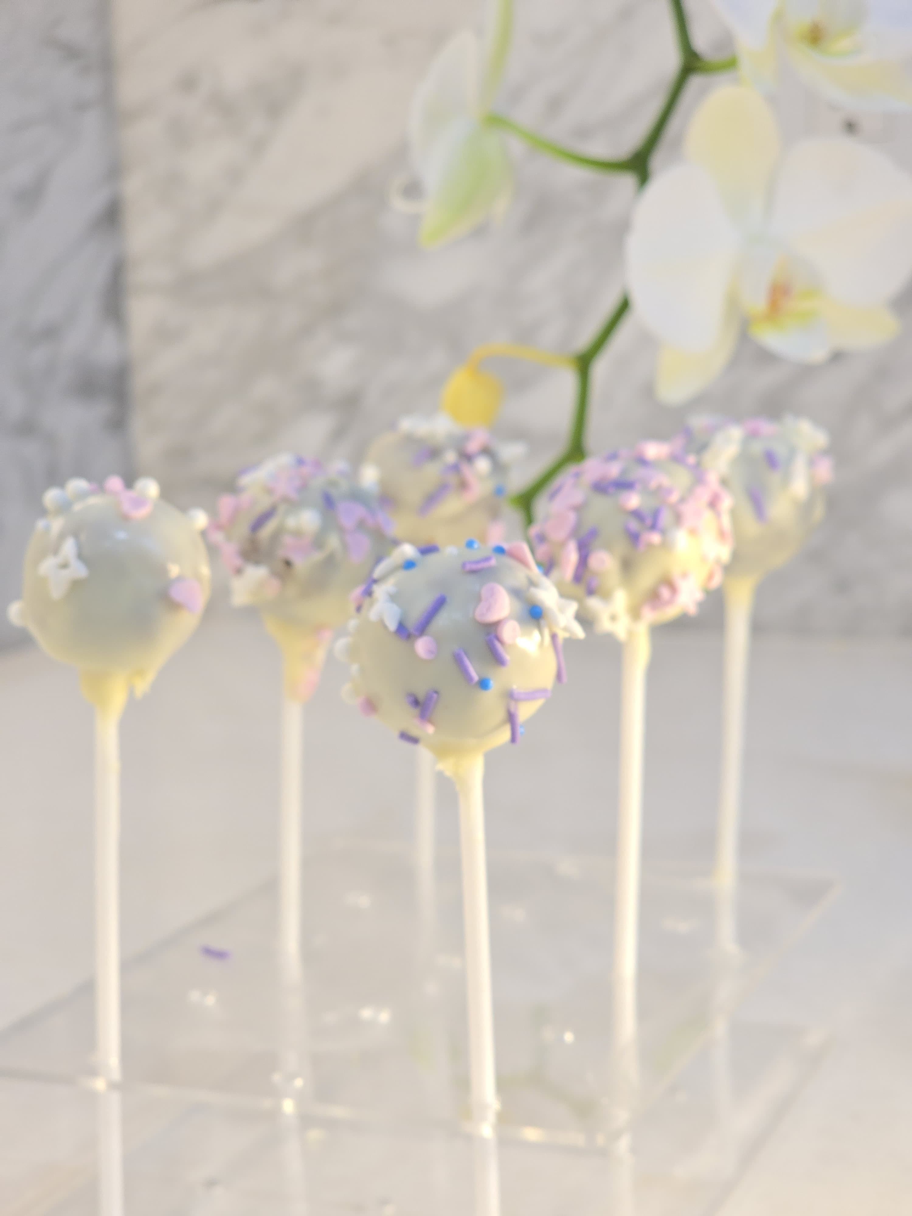 Aum Pops on a tray, chocolate coating catching the light